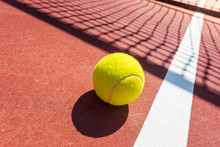 Tennis Ball On A Tennis Court With Net