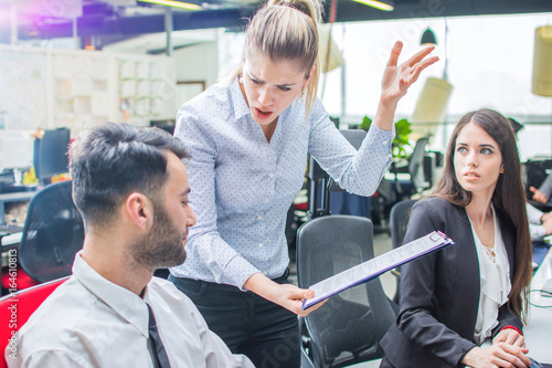 Fotografía Angry businesswoman shouting to a stressed employee at office.