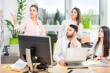 Wall Mural - Business woman presenting to colleagues during meeting at office.