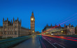 London, England - The famous Big Ben and Houses of Parliament with lights of double decker buses taken on Westminster Bridge at dawn