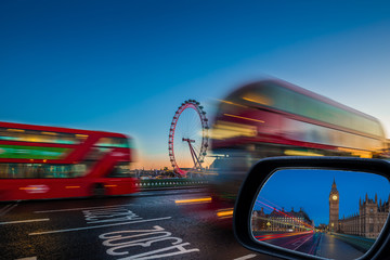 Wall Mural - London, England - Traditional red double decker buses on the move on Westminster Bridge with Big Ben and Houses of Parliament at background at dusk