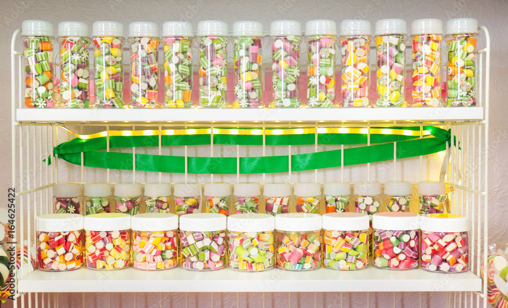 Different sweets in jars at candy shop