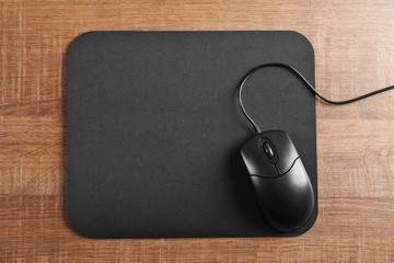 Canvas Print - Blank mat and computer mouse on wooden background