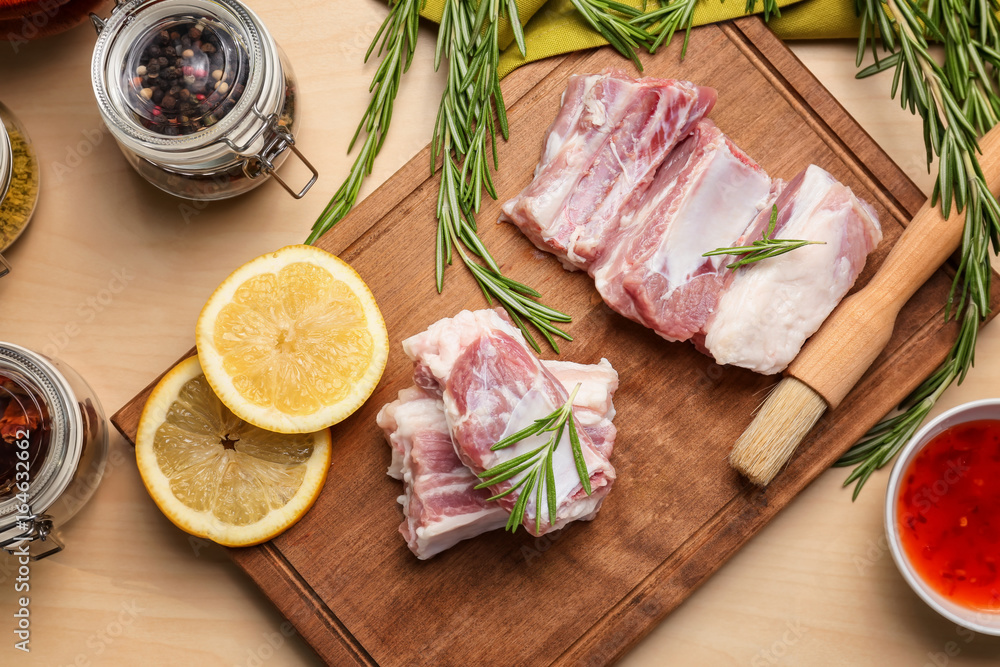 Raw ribs with spices on kitchen table