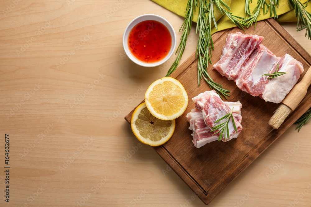 Raw ribs with ingredients on kitchen table