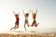 © alphaspirit - Happy smiling friends jumping at the beach