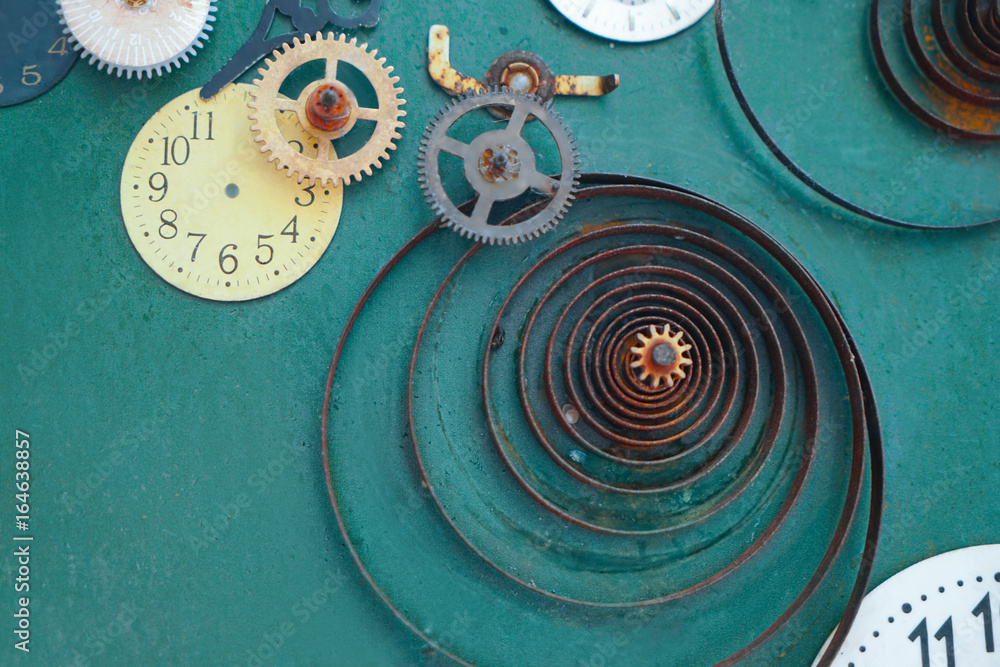 Creative composition with parts of mechanical clock on grunge background