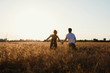 © tol_u4f - Romantic Couple at Sunset. Two people in love at sunset or sunrise. Man and woman on field