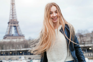 happy young woman in Paris near Eiffel tower, smiling girl traveling portrait, student in Europe