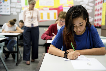 Wall Mural - students doing the exam in classroom