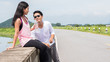 © rachaphak - Couple of lover resting and drinking water while taking a break from running