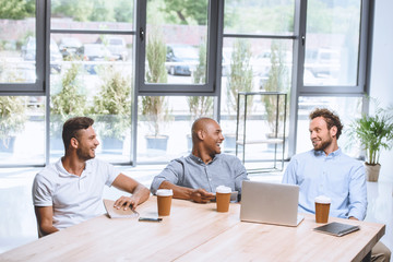 Canvas Print - multicultural business people discussing business strategy at meeting in office