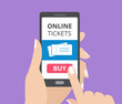© Olga Prozorova - Hand holding smartphone with buy button and tickets icon on screen. Concept of online tickets mobile application.