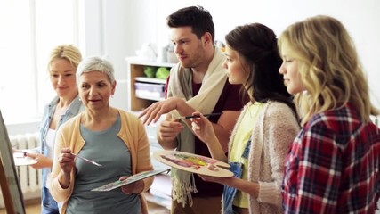 Wall Mural - group of artists discussing painting at art school