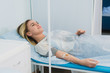 © romankosolapov - Pensive woman transfused lying in hospital ward