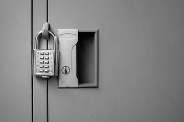 Closeup padlock with key number hanging on locker for concept technology data log security on black and white