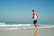 © Dusan Petkovic - Young handsome man wearing a cap while running on the beach.