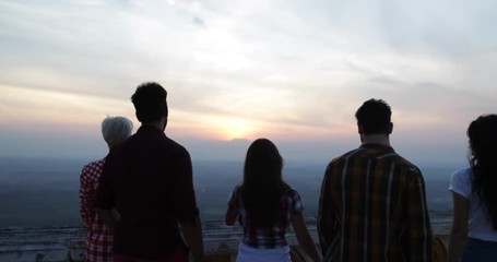Wall Mural - people on mountain top back rear view enjoying landscape, friends group tourists looking at sunrise 