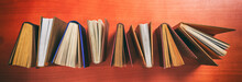Vintage Books Standing On Wooden Background - Top View