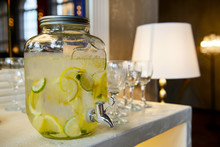 Drinking Lemon Water In The Jar With The Tap. Juice Original Homemade. Cooling And Refreshing Drink.