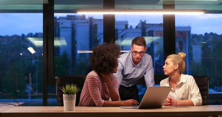 Wall Mural - Multiethnic startup business team in night office