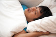 © suthisak - Asian man is snoring in bed and his have sleep apnea, Health care concept.