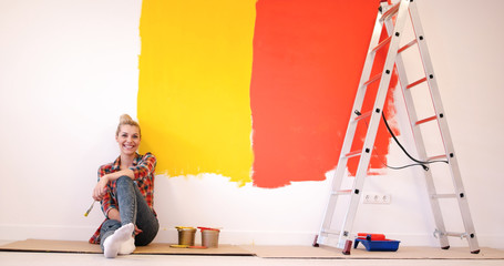 Wall Mural - young female painter sitting on floor