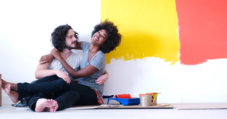 Wall Mural - young multiethnic couple relaxing after painting