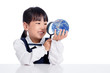 Leinwandbild Motiv Asian Little Chinese Girl Looking At Globe Through Magnifying Glass