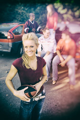 Wall Mural - Tailgating: Female Football Fan With Friends In Background