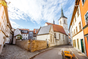 beautiful street view with colorful buildings and church tower in the old town of erfurt city during