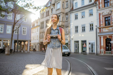 Wall Mural - Portrait of a young woman tourist walking on the street in the old town of Erfurt city, Germany