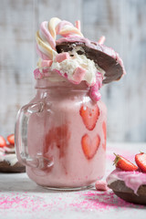 Wall Mural - Pink strawberry freakshake milkshake with sweets donut and marshmallow