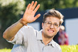 © LIGHTFIELD STUDIOS - portrait of smiling young man waving while looking at camera
