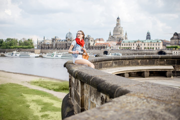 Wall Mural - Lifestyle portrait of a stylish woman on the bridge traveling in Dresden city, Germany