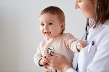 Sticker - doctor with stethoscope listening baby at clinic