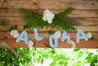 Aloha on wooden background, party Hawaiian-style,
