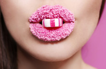Beautiful Young Woman Holding Candy In Lips Covered With Sugar, Closeup