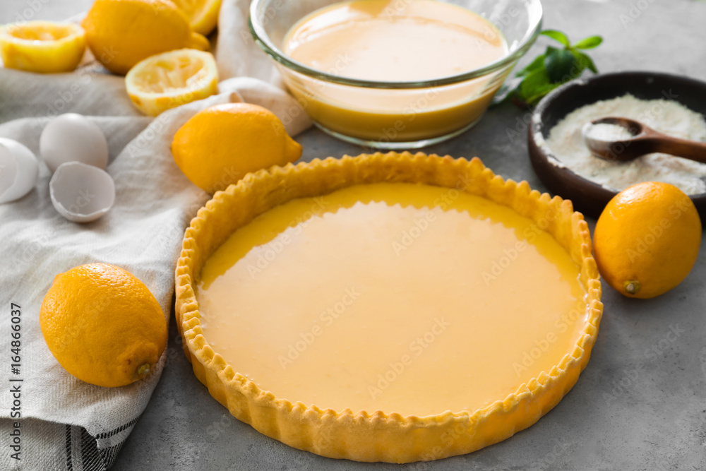 Uncooked lemon pie and ingredients on table