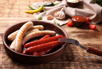 Sticker - Plate with assorted roasted sausages on wooden background