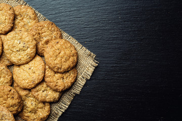 Biscuit sweet cookie background. Domestic stacked butter biscuit pattern concept,close up macro.Homemade cookies on wooden table.Cereal biscuits with the sesame,peanuts,sunflower and amaranth.