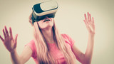 Fototapeta Do pokoju - Girl wearing virtual reality goggles.