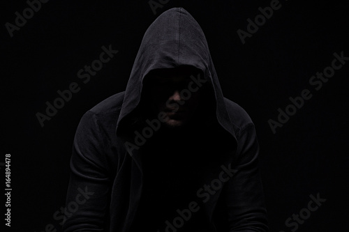 Cuadros en Lienzo Young man in hood and shadow