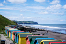  Whitby, North Yorkshire, England - July 1, 2017:,UK - Row Of Colorful Beach Huts At Whitby Beach On A Beautiful Sunny Day In The Summer