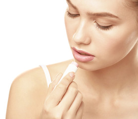 Canvas Print - Closeup view of beautiful young woman applying lipstick, white background