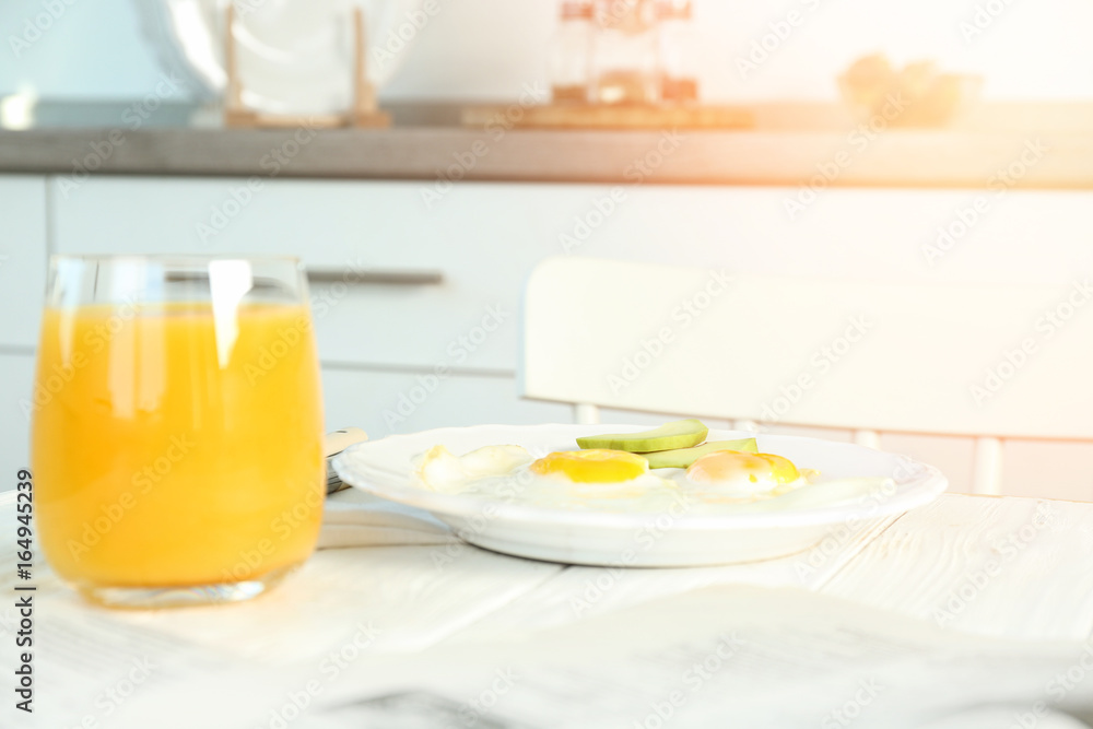 Delicious breakfast with over easy eggs on kitchen table