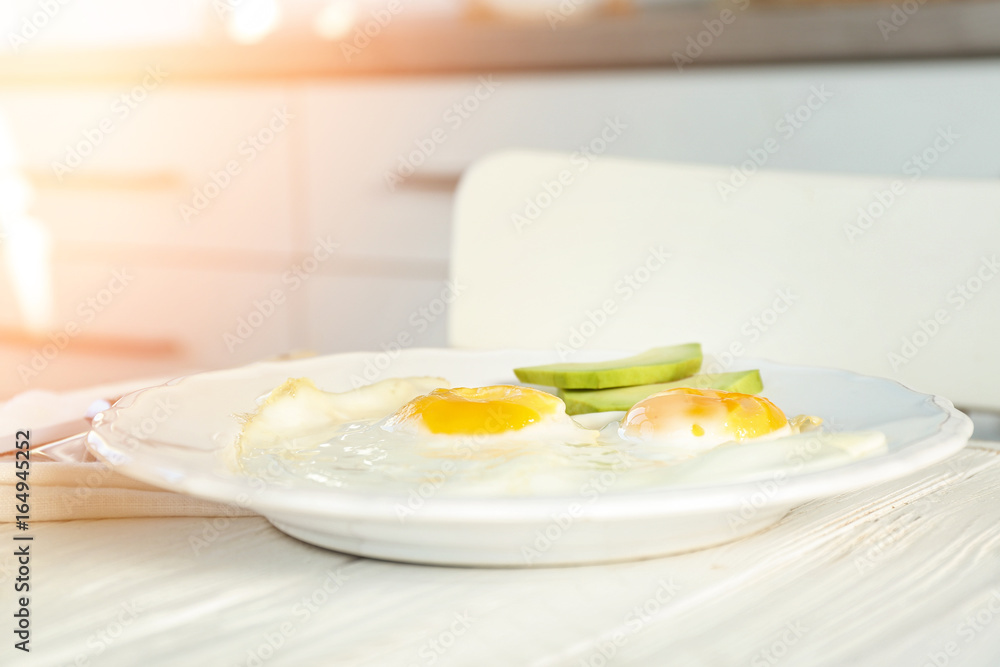 Delicious breakfast with over easy eggs on kitchen table