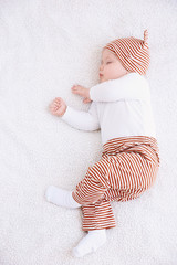 Wall Mural - Cute little baby sleeping on plaid at home