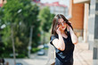 © AS Photo Family - Brunette girl at black dress, sunglasses posing at street of city.