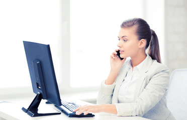 Wall Mural - businesswoman with smartphone in office